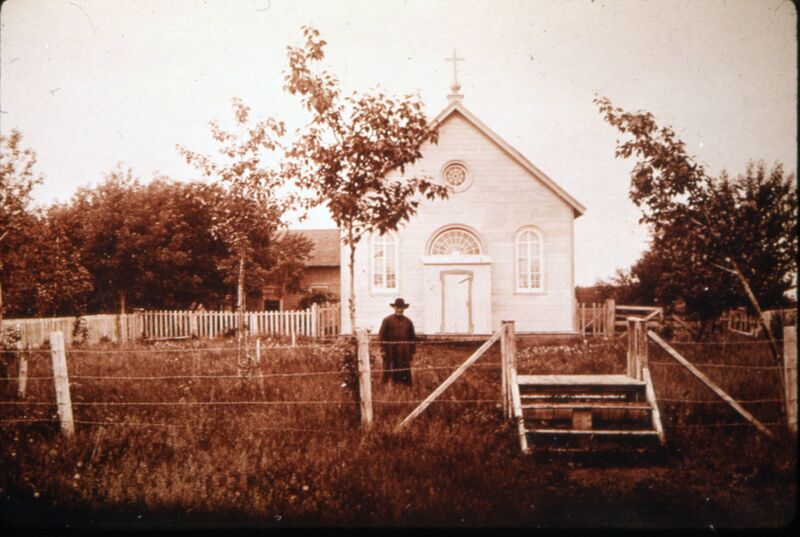 File:Man standing in front of St. Charles Roman Catholic Church, Charleswood, Winnipeg, Manitoba.jpg